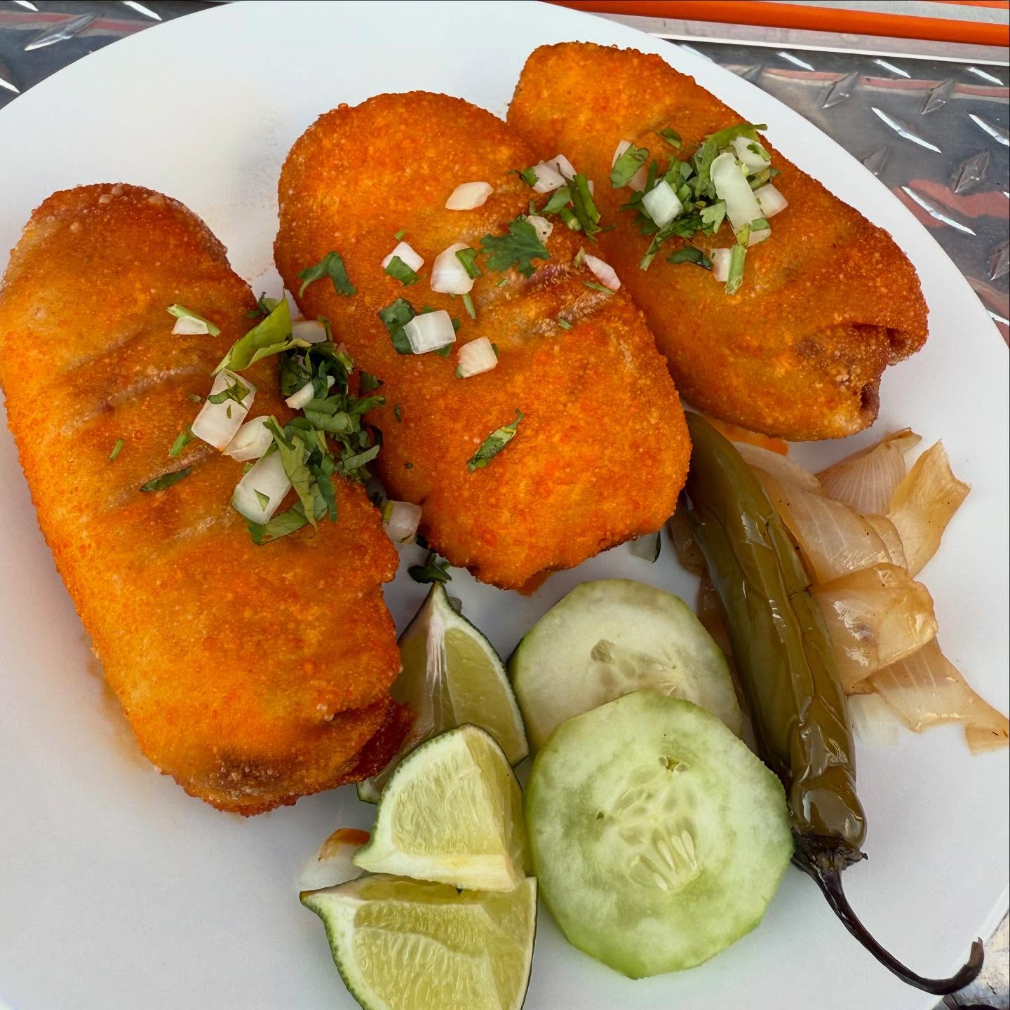 Bam Bam birria eggrolls fried golden with onion and cilantro