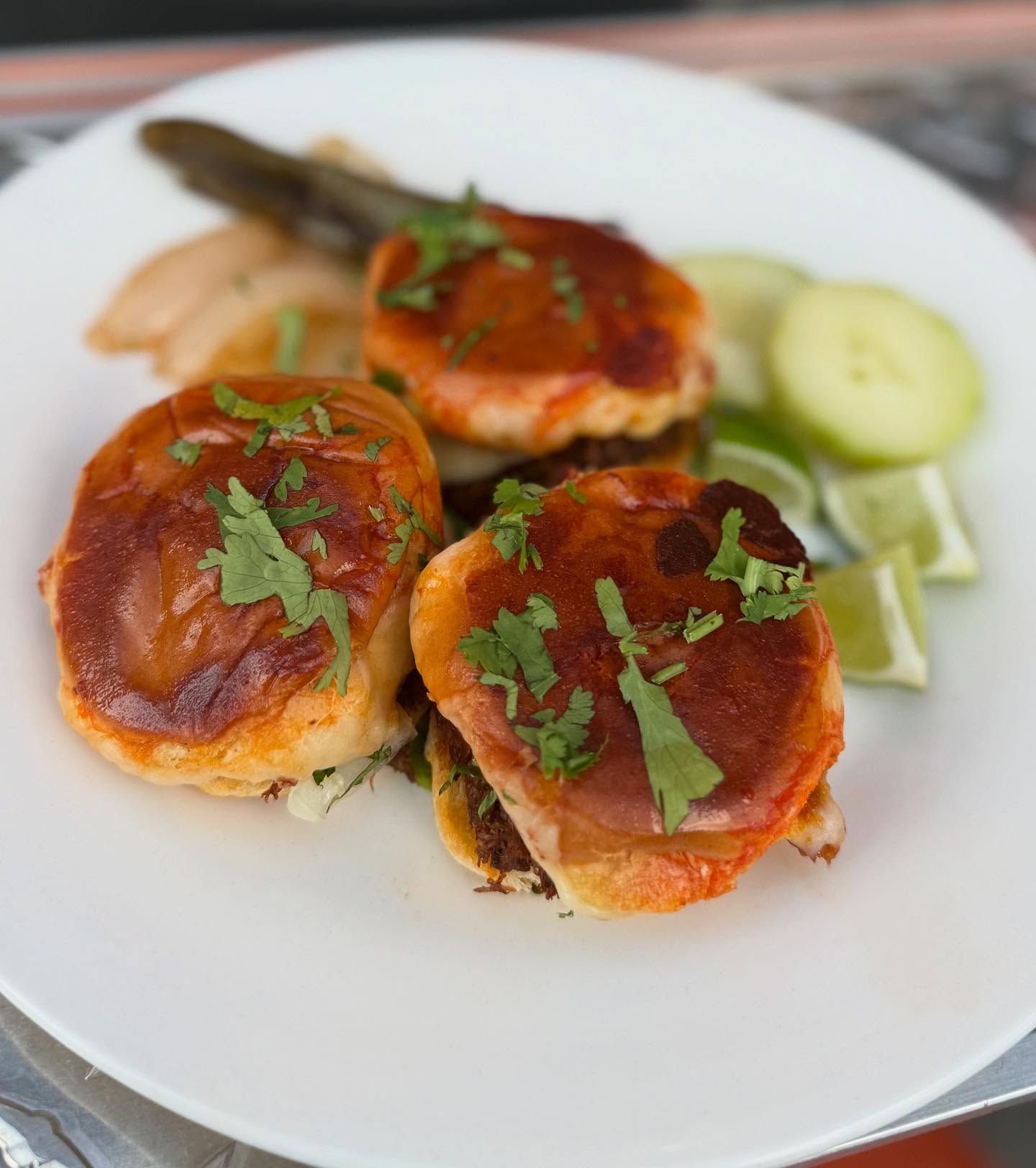Crispy cheese-crusted birria mulitas on a plate